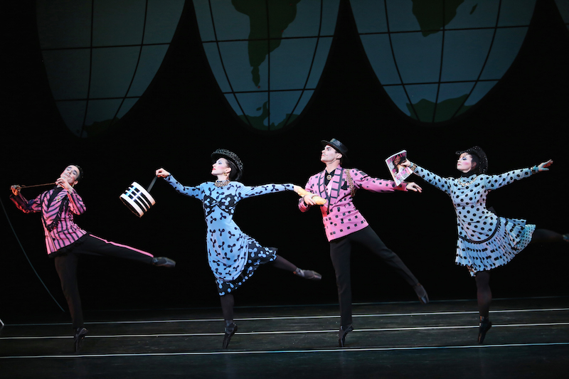 A quartet wearing pink and blue pastel overcoats and black pointe shoes